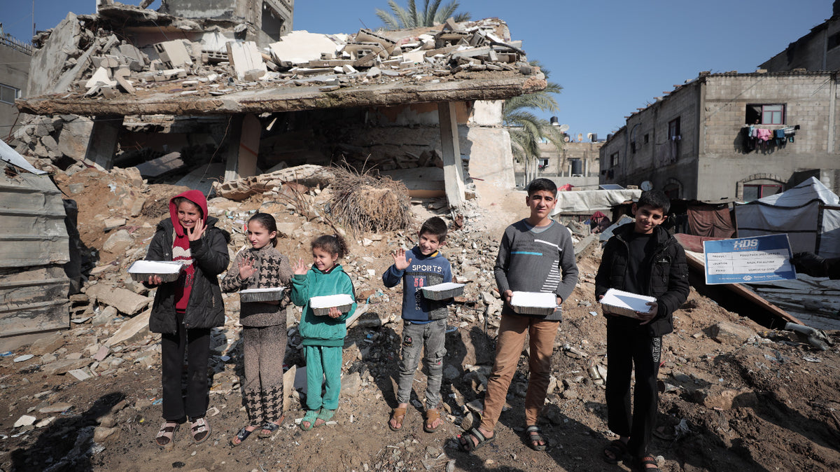 Aid workers preparing hot meals for families in Palestine